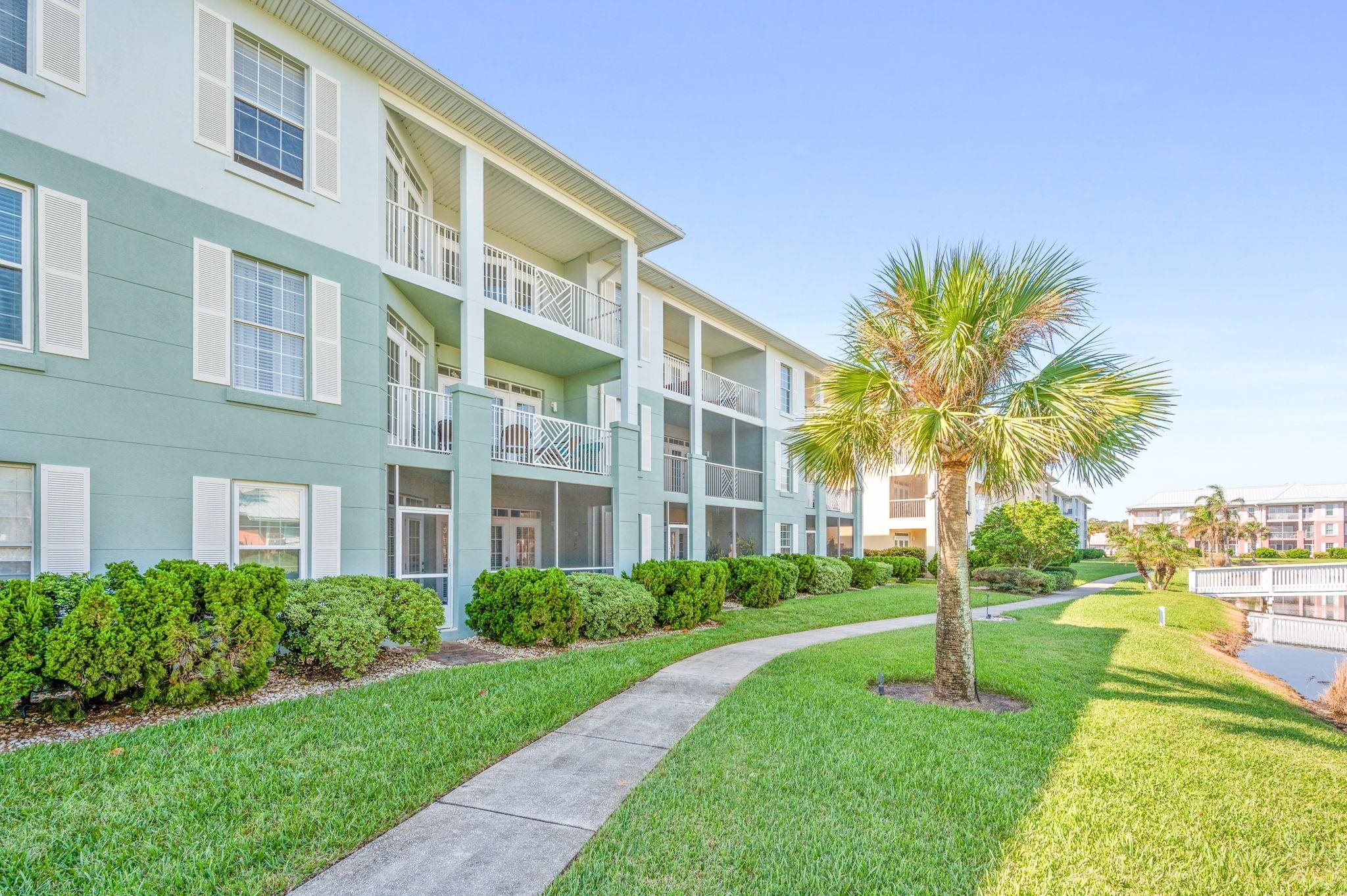 285 Atlantis Circle, Unit 203 St. Augustine, FL 32080 - Photo 2 of 71 a view of a building with a yard