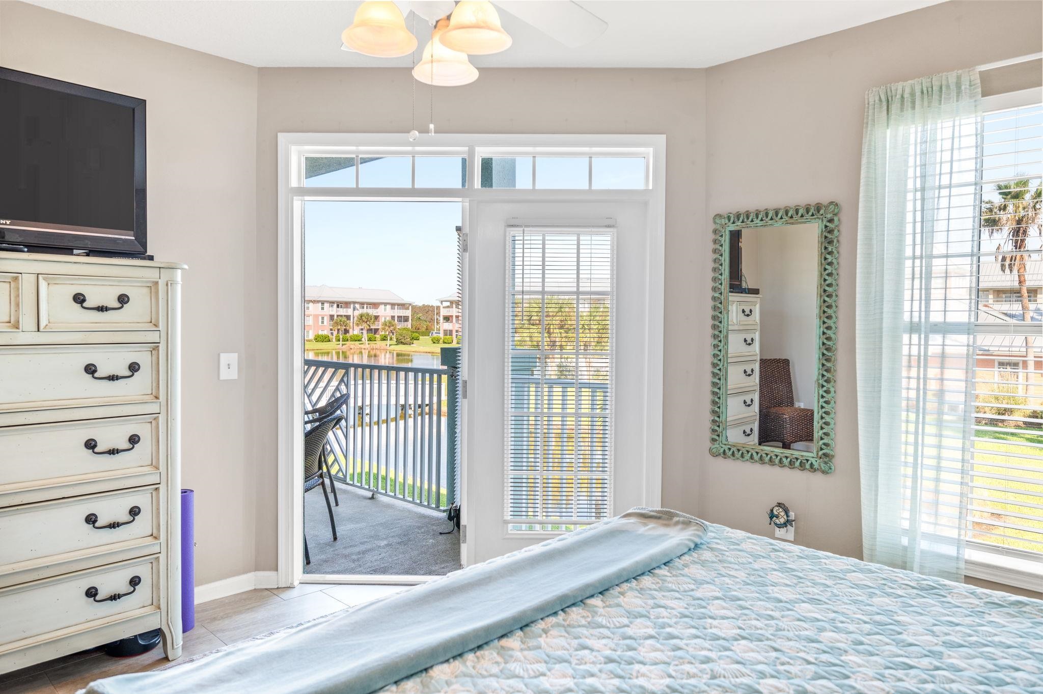 285 Atlantis Circle, Unit 203 St. Augustine, FL 32080 - Photo 25 of 71 a view of a bedroom with cabinet flat screen tv and windows
