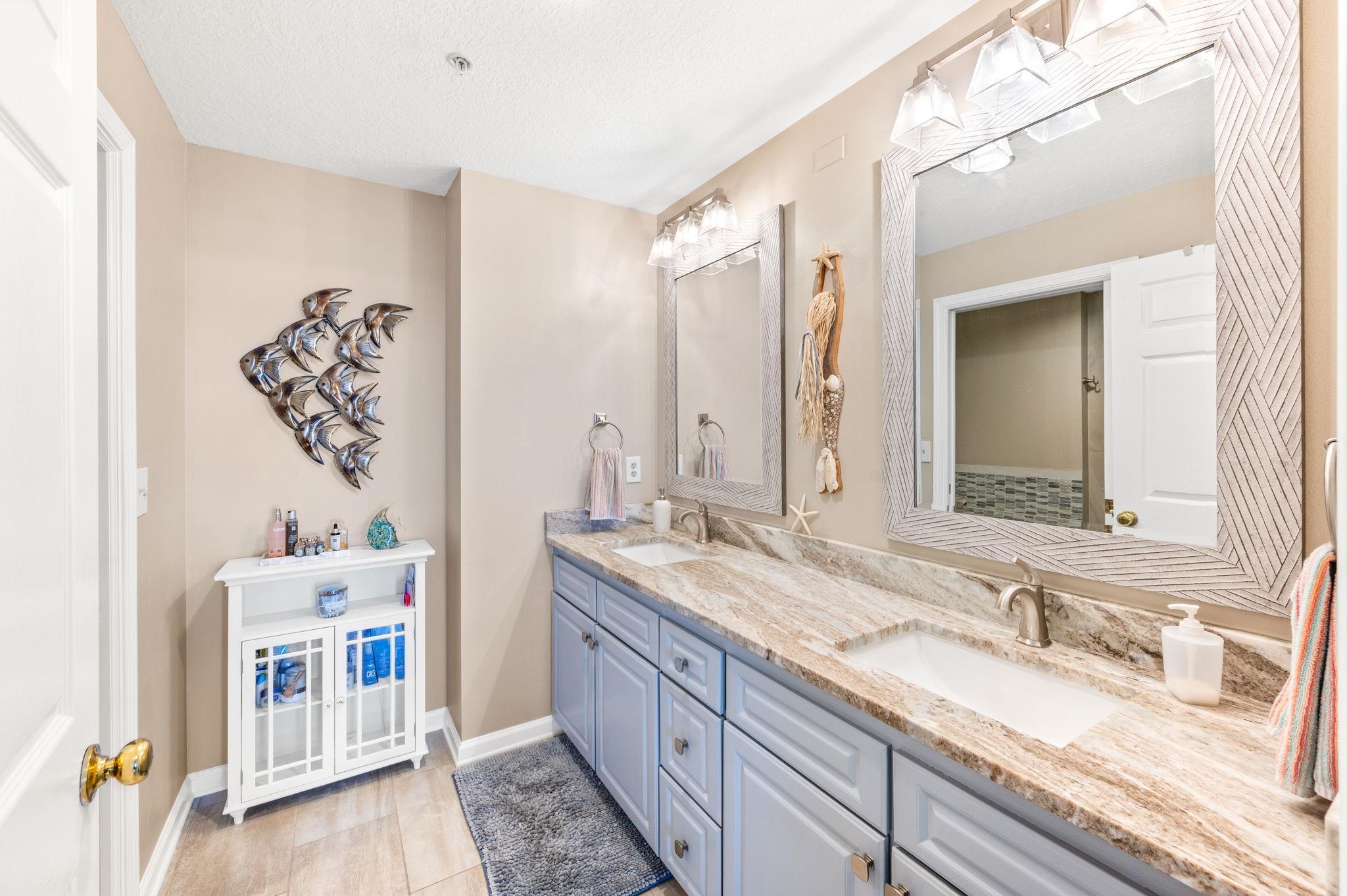 285 Atlantis Circle, Unit 203 St. Augustine, FL 32080 - Photo 28 of 71 a bathroom with a double vanity sink and a mirror