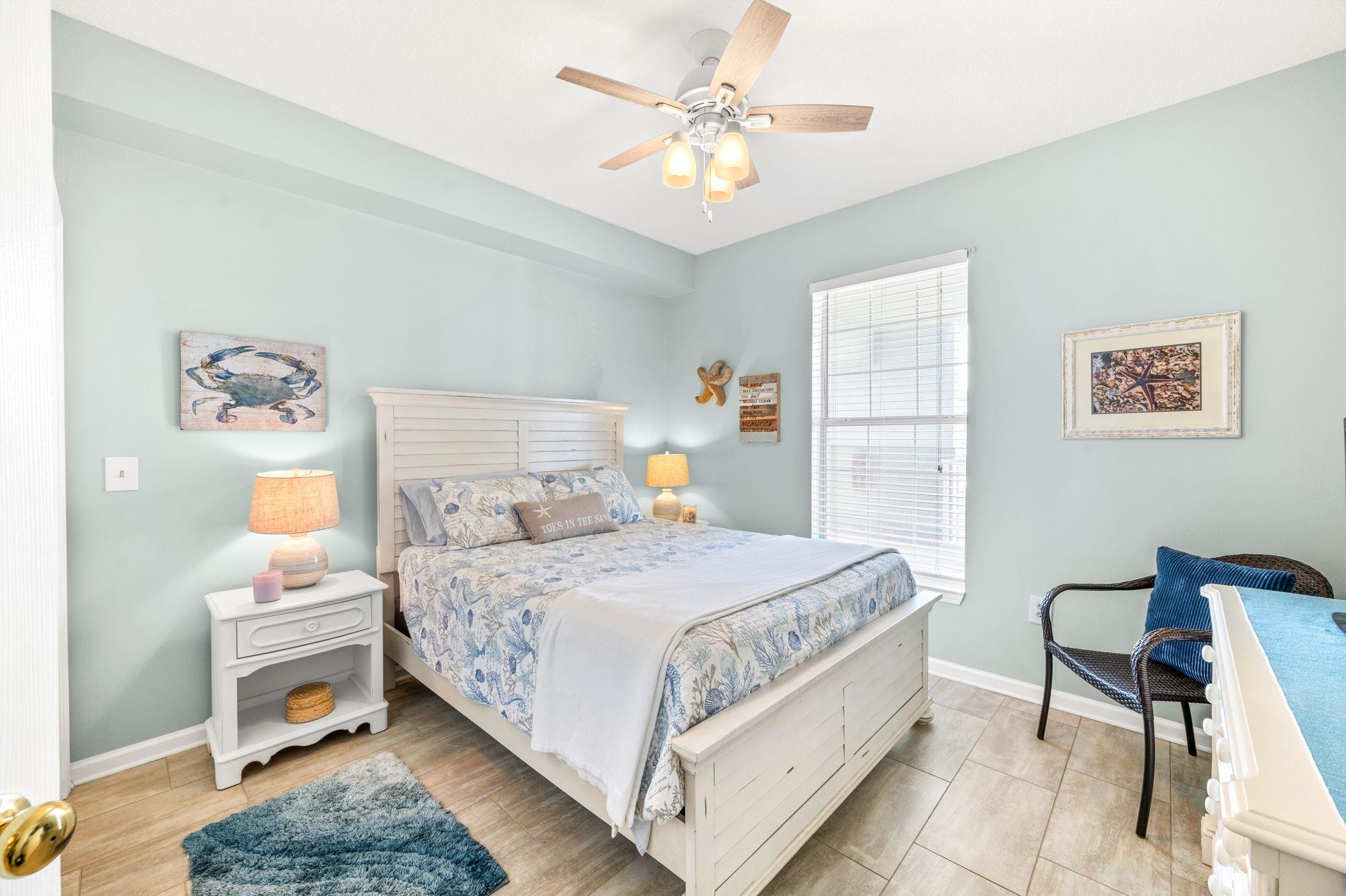 285 Atlantis Circle, Unit 203 St. Augustine, FL 32080 - Photo 38 of 71 a bedroom with a bed and a chandelier