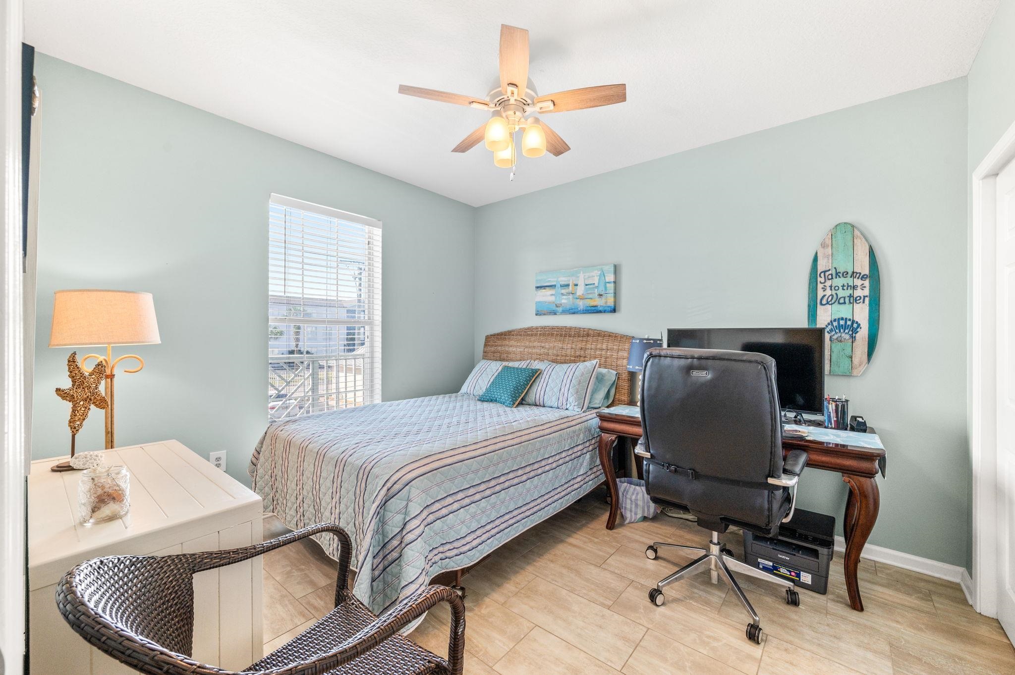 285 Atlantis Circle, Unit 203 St. Augustine, FL 32080 - Photo 44 of 71 a bedroom with a bed and a chandelier