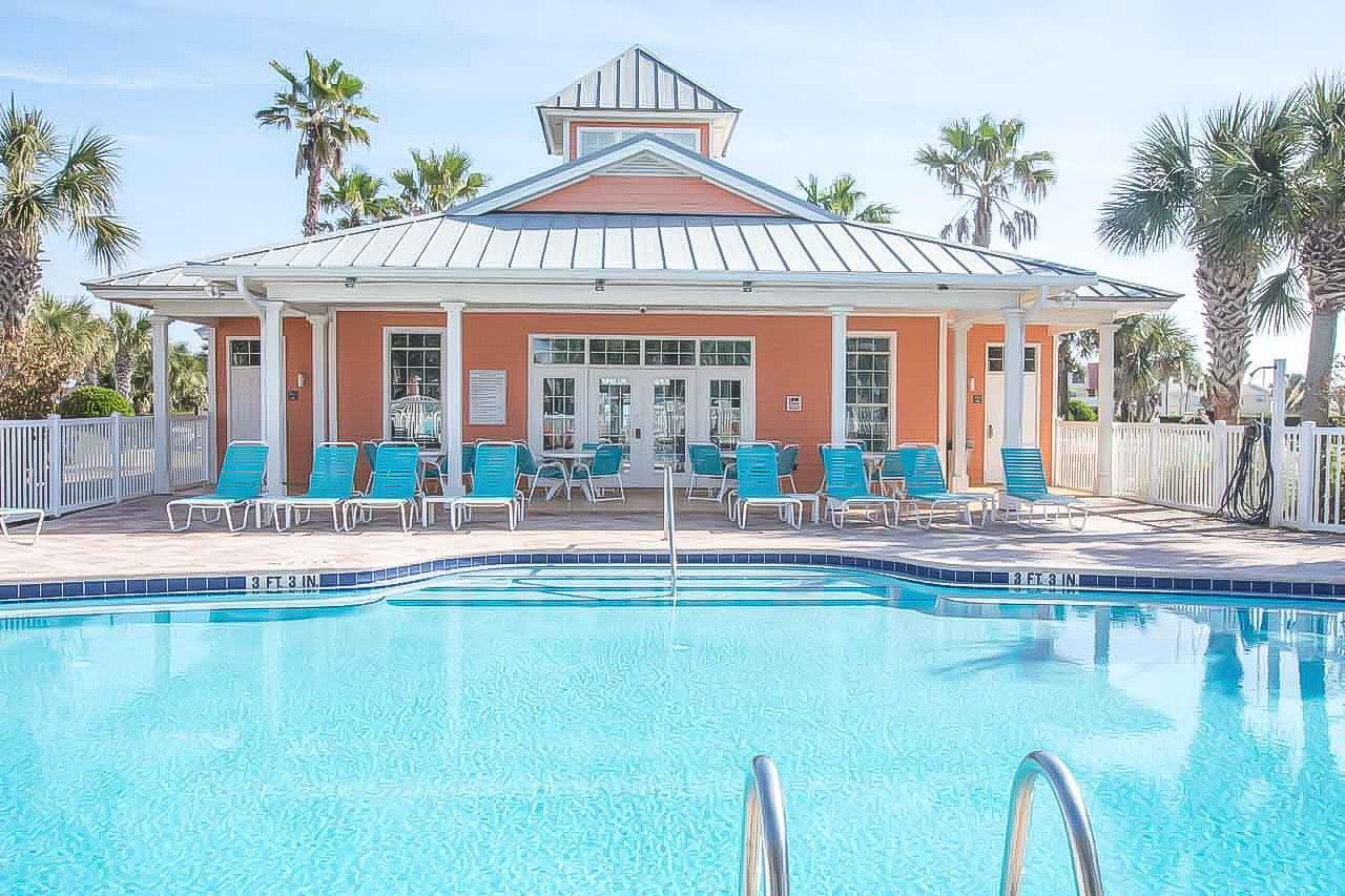 285 Atlantis Circle, Unit 203 St. Augustine, FL 32080 - Photo 56 of 71 a view of a house with swimming pool and a table and chairs