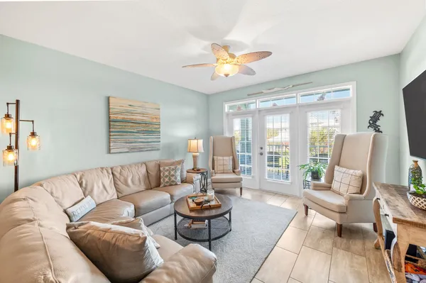 a living room with furniture a rug and a lamp