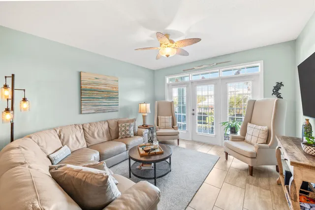 a living room with furniture a rug and a lamp