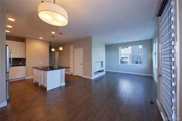 a view of kitchen and hall with wooden floor