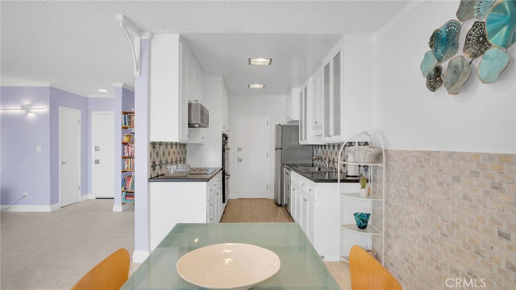 10725 Ohio Avenue, Unit 301 Los Angeles, CA 90024 - Photo 12 of 39 a kitchen with stainless steel appliances kitchen island granite countertop a sink and refrigerator