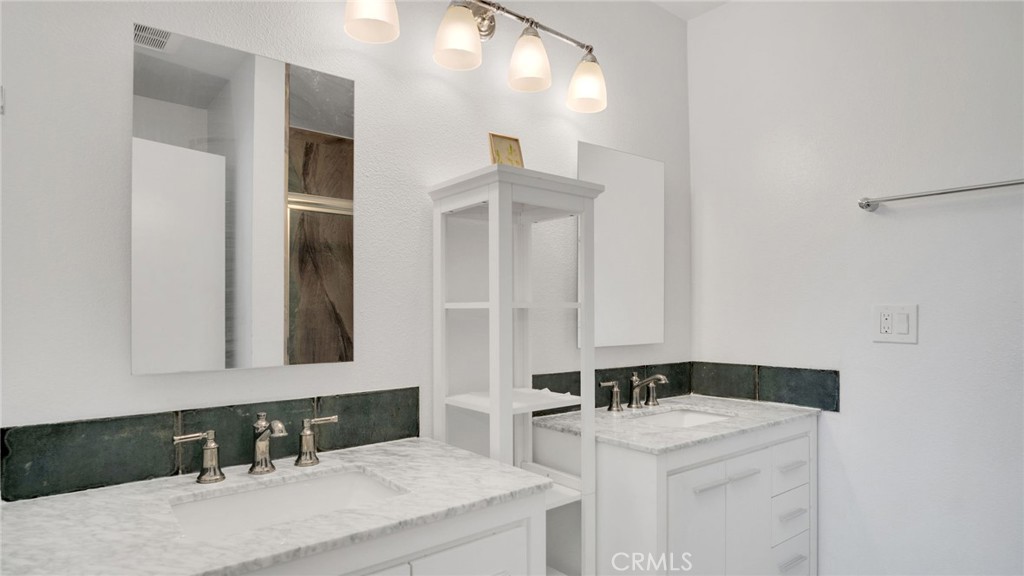 10725 Ohio Avenue, Unit 301 Los Angeles, CA 90024 - Photo 25 of 39 a bathroom with a sink and a mirror