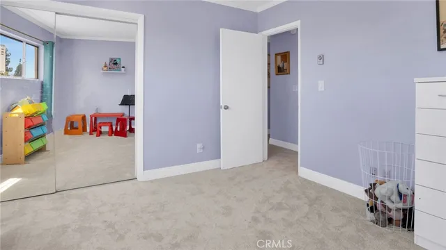 a view of a hallway with wooden floor and closet