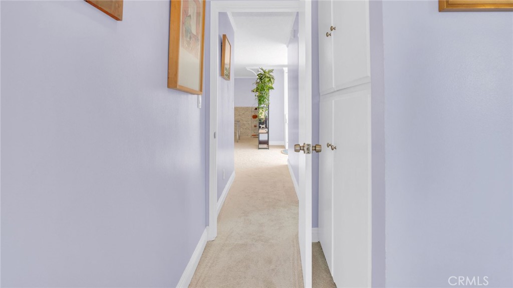 10725 Ohio Avenue, Unit 301 Los Angeles, CA 90024 - Photo 32 of 39 a view of a hallway with wooden floor and a bathroom