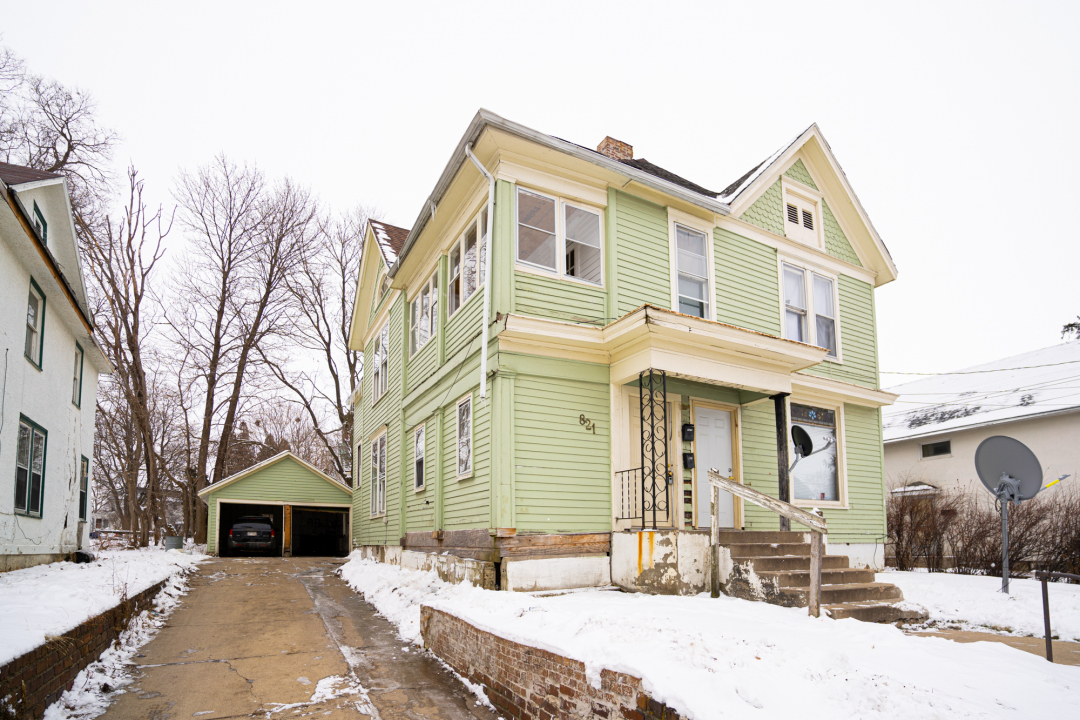 821-823 South Carroll Avenue Freeport, IL 61032 - Photo 2 of 11 a front view of a house with a yard