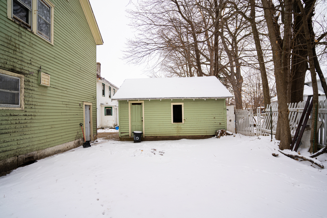 821-823 South Carroll Avenue Freeport, IL 61032 - Photo 8 of 11 a view of a house with a yard and covered with snow