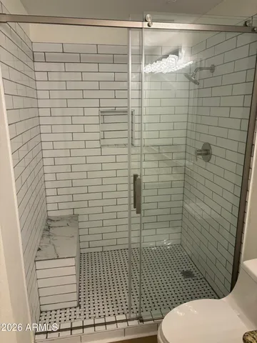 a bathroom with a toilet and shower