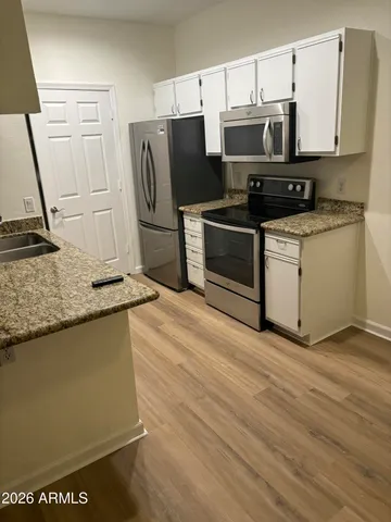 a kitchen with stainless steel appliances a refrigerator stove and microwave