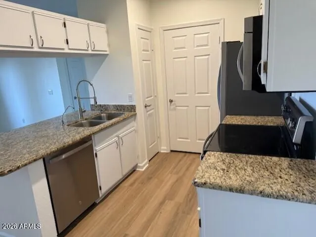 a kitchen with a sink a stove and cabinets
