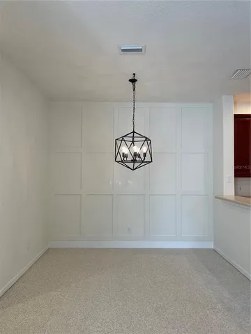 a view of a kitchen with a sink and chandelier