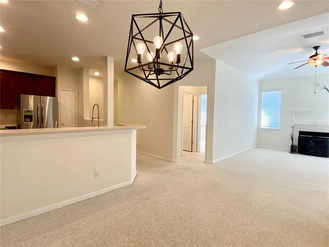 an empty room with fireplace and fan