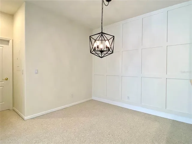 an empty room with a ceiling fan and window