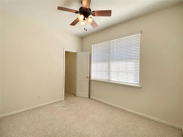 an empty room with ceiling fan