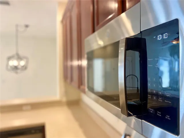 a kitchen with stainless steel appliances granite countertop a sink a stove and a microwave