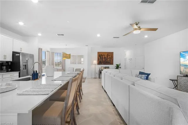 a living room with furniture and a kitchen