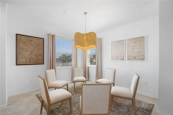 a dining room with furniture and a window