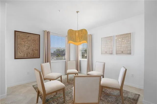 a dining room with furniture and a window