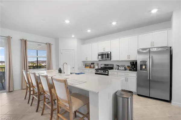 a kitchen with stainless steel appliances a refrigerator stove microwave and cabinets