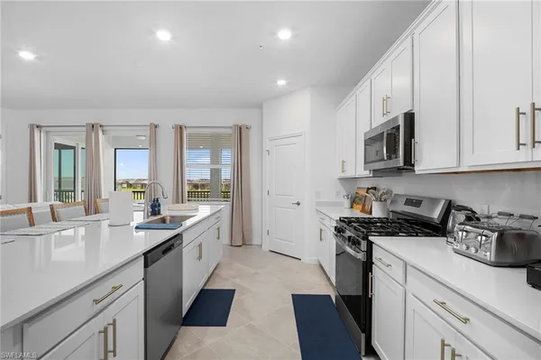 a kitchen with stainless steel appliances granite countertop a sink stove and cabinets