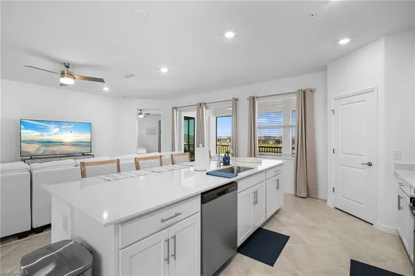 a kitchen with sink stove and refrigerator