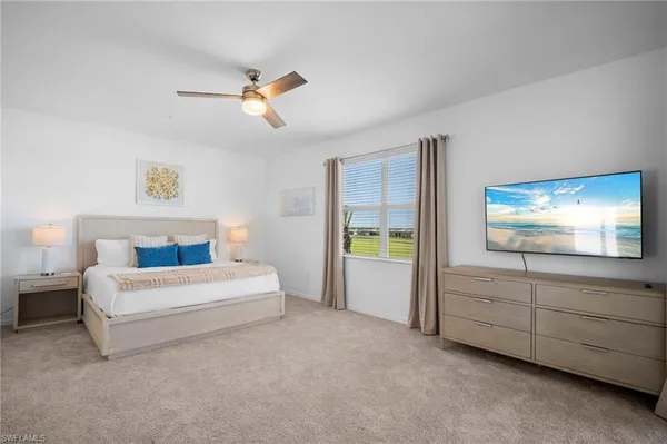 a spacious bedroom with a bed and a window