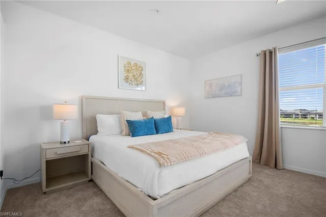 a bedroom with a bed and a lamp