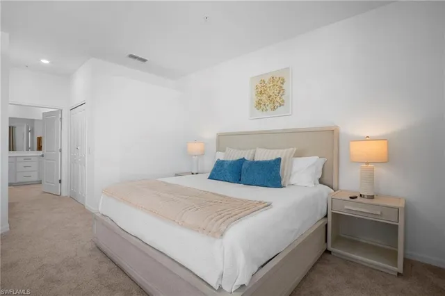 a bedroom with a bed and a lamp