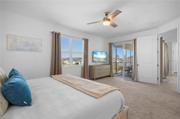 a spacious bedroom with a bed and a chandelier