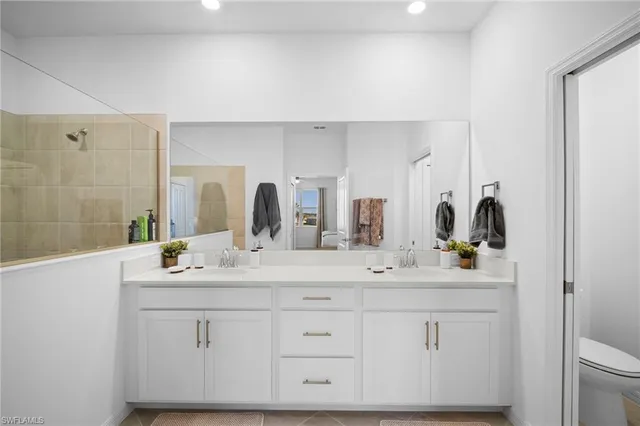 a bathroom with a double vanity sink mirror and double