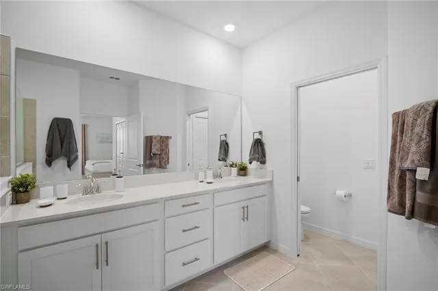 a bathroom with a double vanity sink and mirror