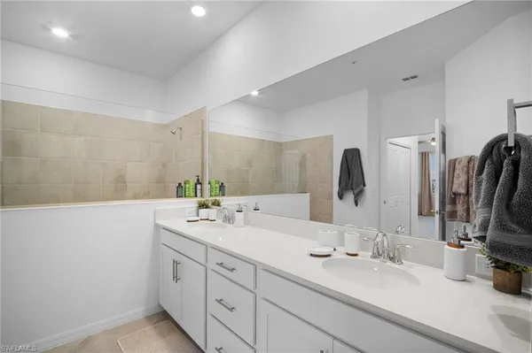 a bathroom with double sink and a mirror