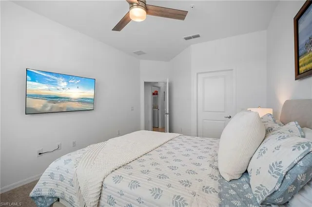 a bedroom with a bed and a painting on the wall