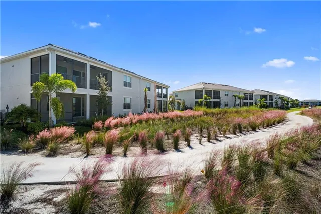 a front view of a house with a yard and outdoor seating
