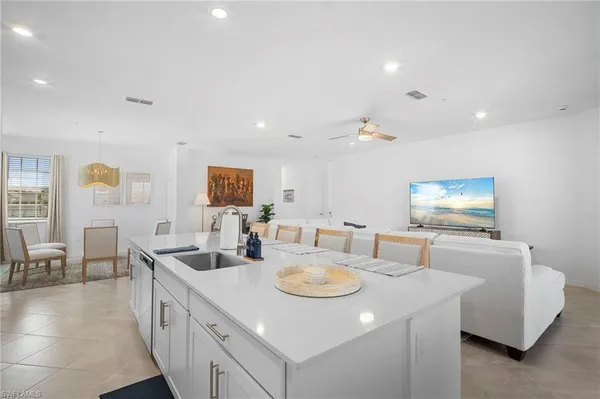 a kitchen with kitchen island appliances and living room