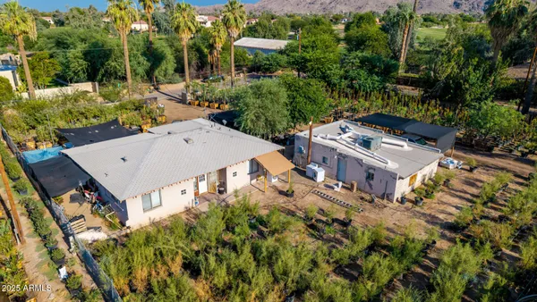 an aerial view of a house with a yard
