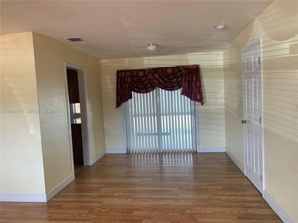 a view of an empty room with a window