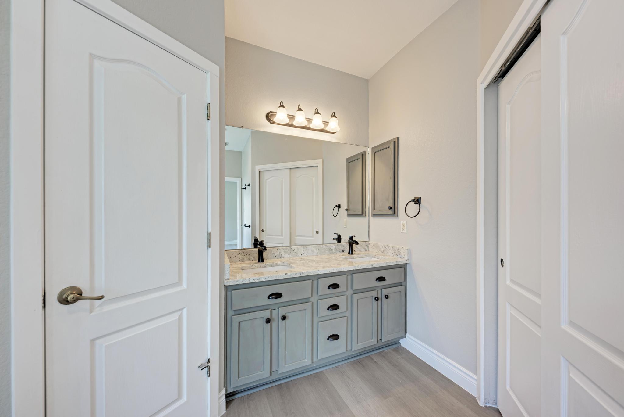 4408 Tello Path Austin, TX 78749 - Photo 22 of 38 Full bathroom with double vanity and wood finished floors