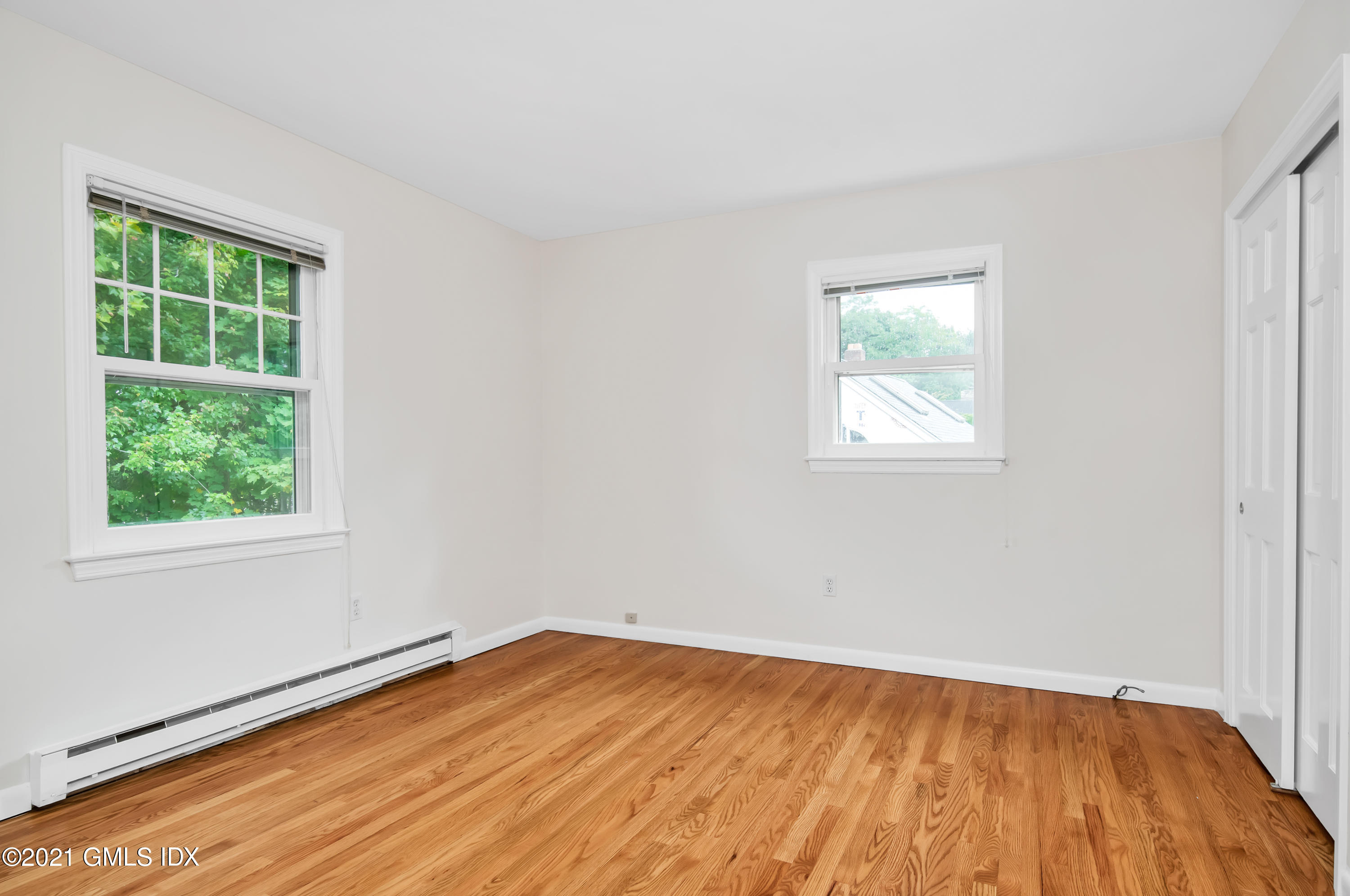 30 Pleasant Street Riverside, CT 06878 - Photo 14 of 19 an empty room with wooden floor and windows