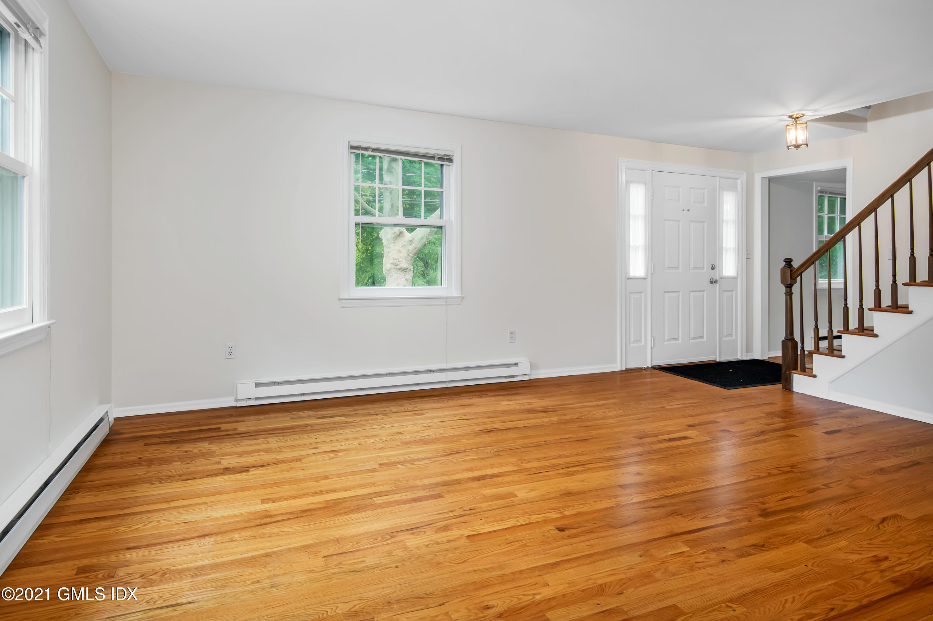 30 Pleasant Street Riverside, CT 06878 - Photo 3 of 19 a view of an empty room with wooden floor and a window