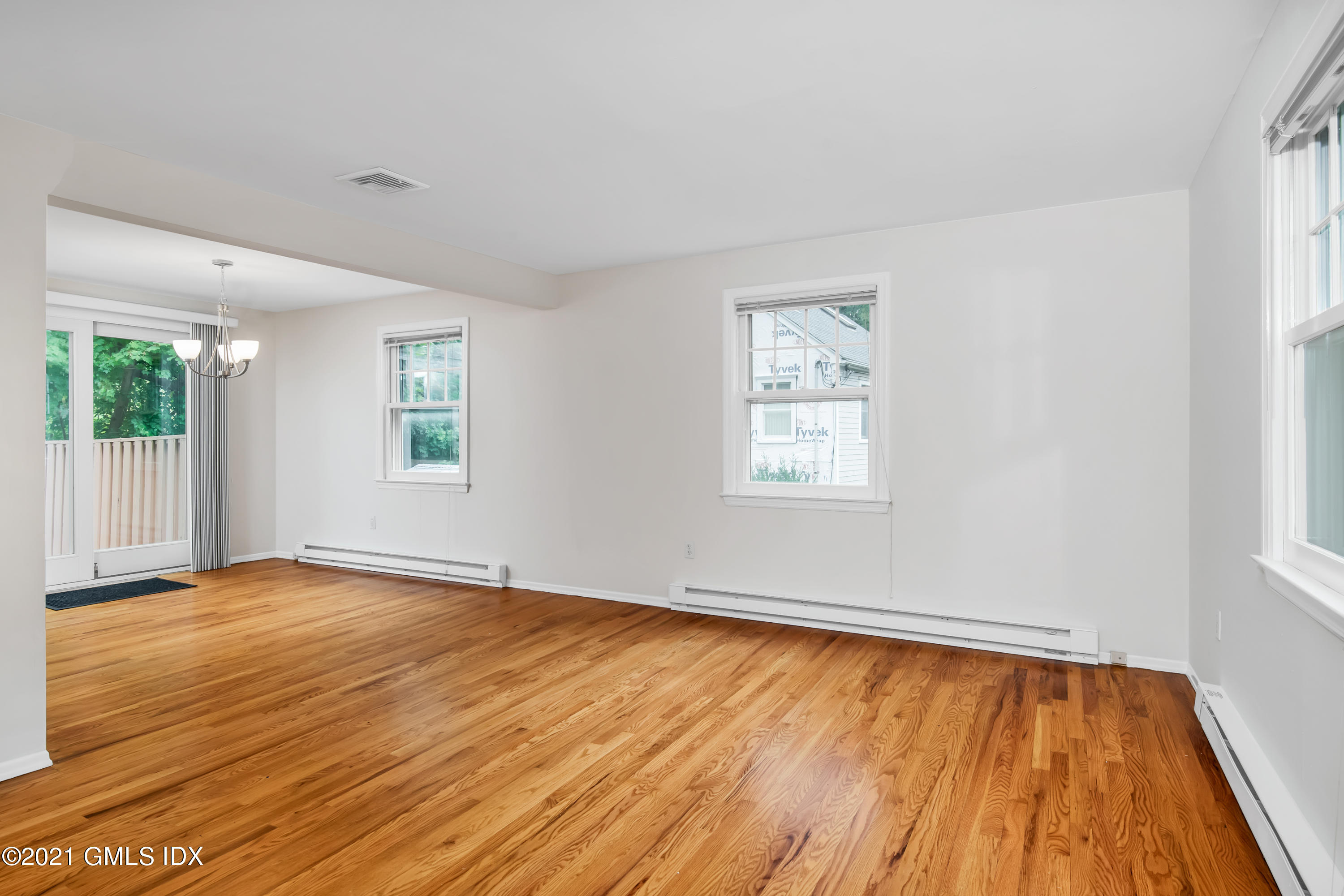 30 Pleasant Street Riverside, CT 06878 - Photo 4 of 19 an empty room with wooden floor and windows