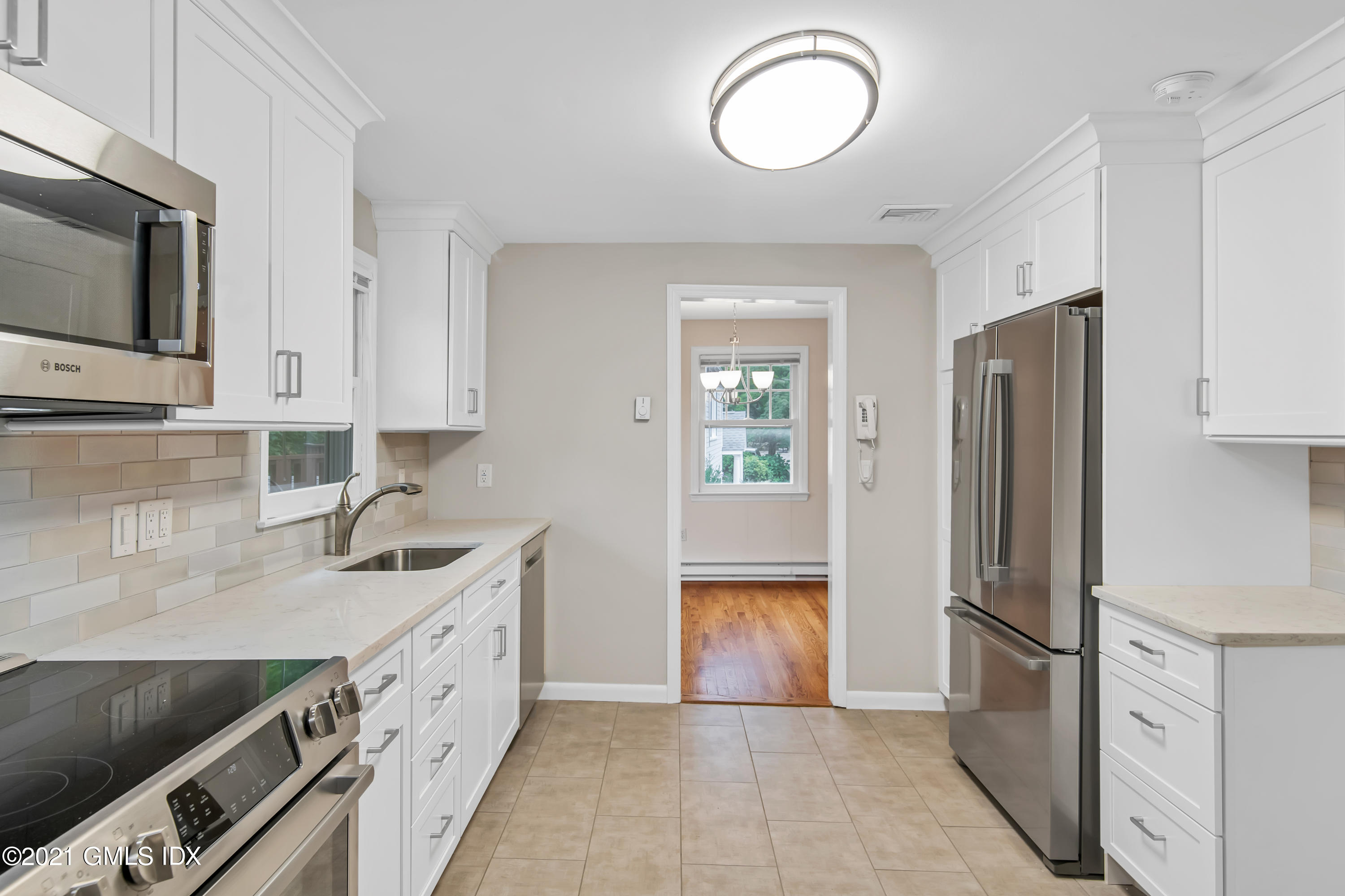 30 Pleasant Street Riverside, CT 06878 - Photo 6 of 19 a kitchen with stainless steel appliances granite countertop a refrigerator a stove and a sink