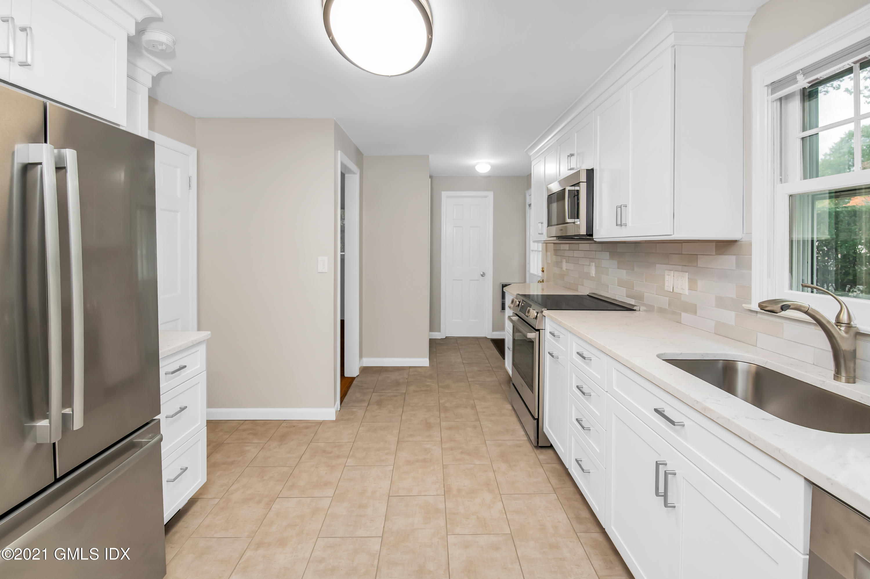 30 Pleasant Street Riverside, CT 06878 - Photo 7 of 19 a kitchen with stainless steel appliances granite countertop a refrigerator and a sink