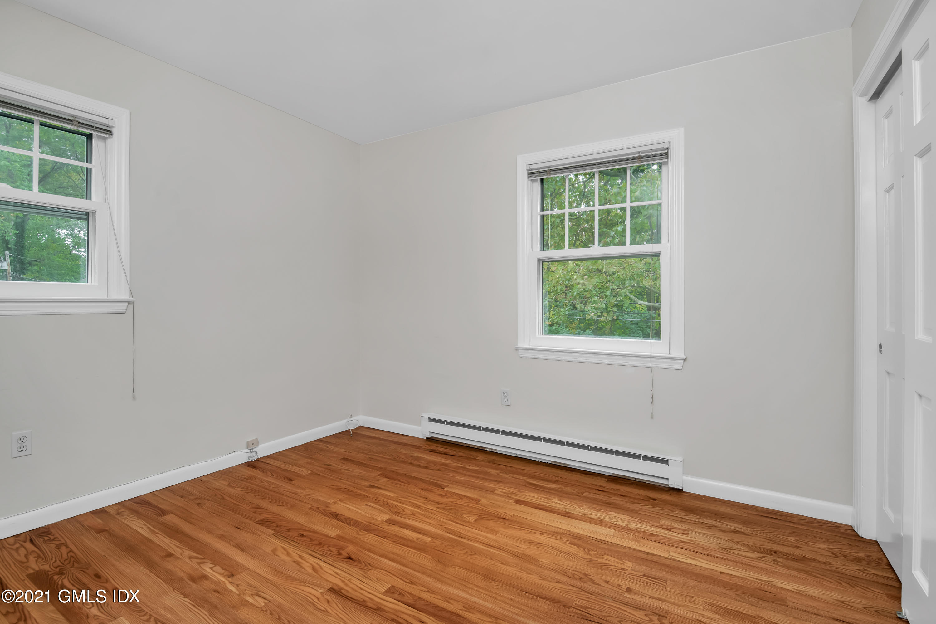 30 Pleasant Street Riverside, CT 06878 - Photo 10 of 19 a view of an empty room with wooden floor and a window