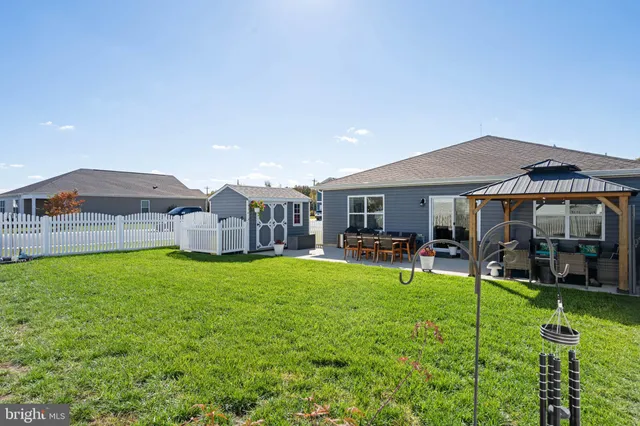 a view of a house with backyard porch and sitting area