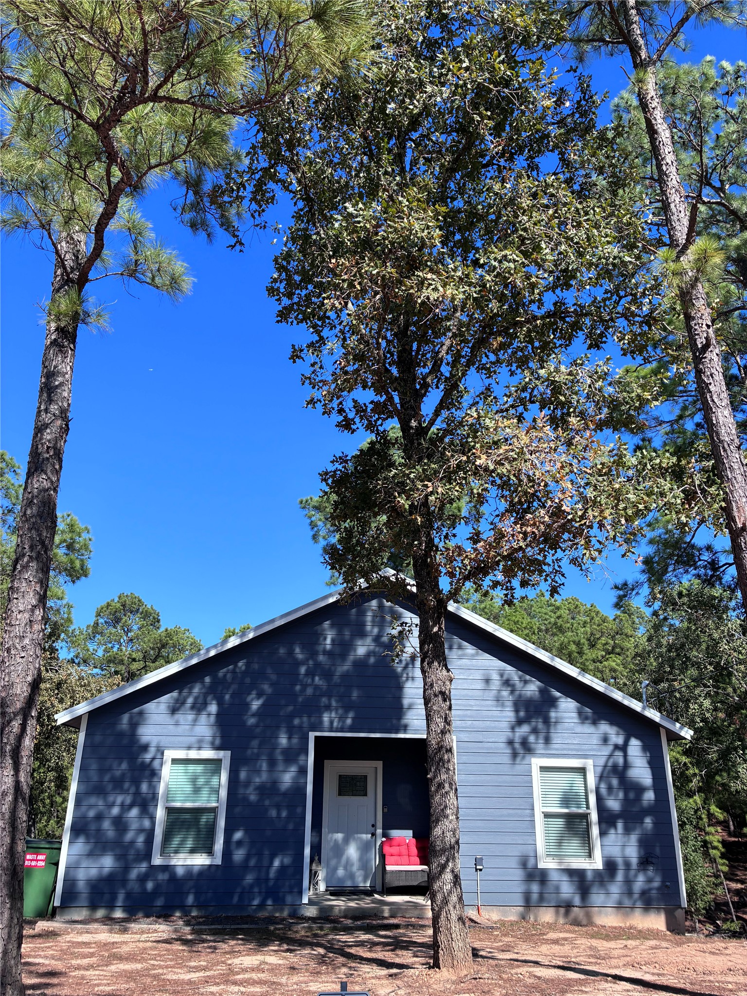 a front view of a house with a tree